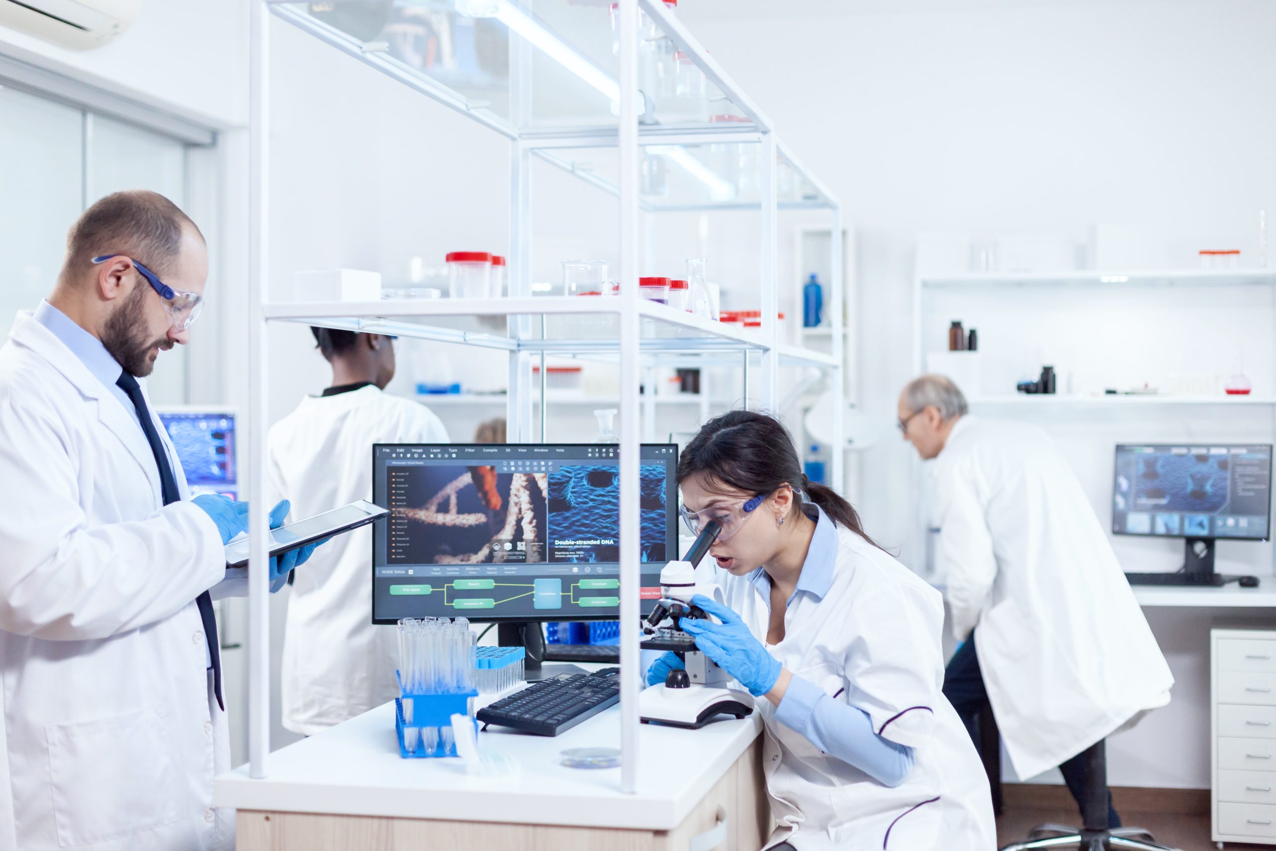 a medical lab with scientists looking at blood samples to show the importance of medical billing for laboratories