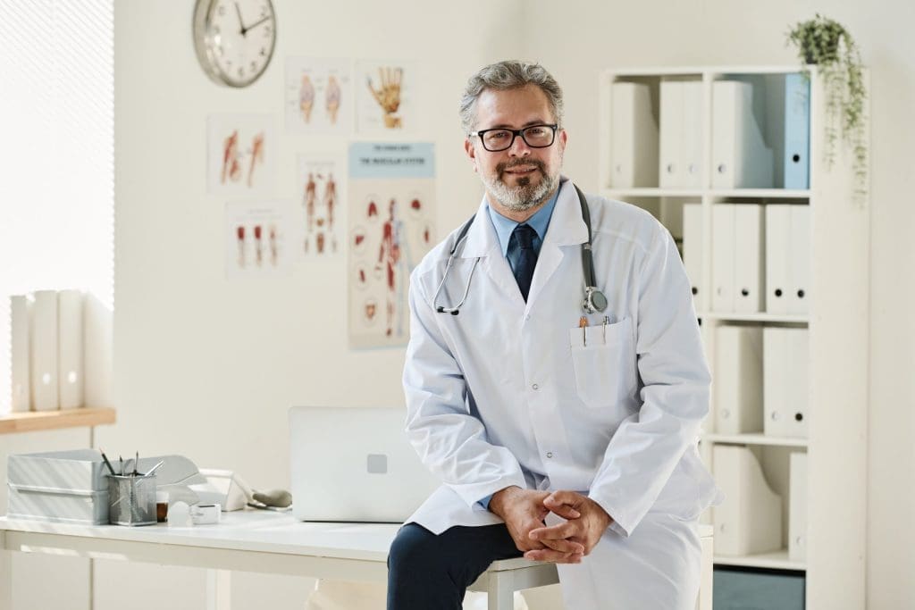 a doctor in his office looking at us representing the importance of physicians billing in his practice