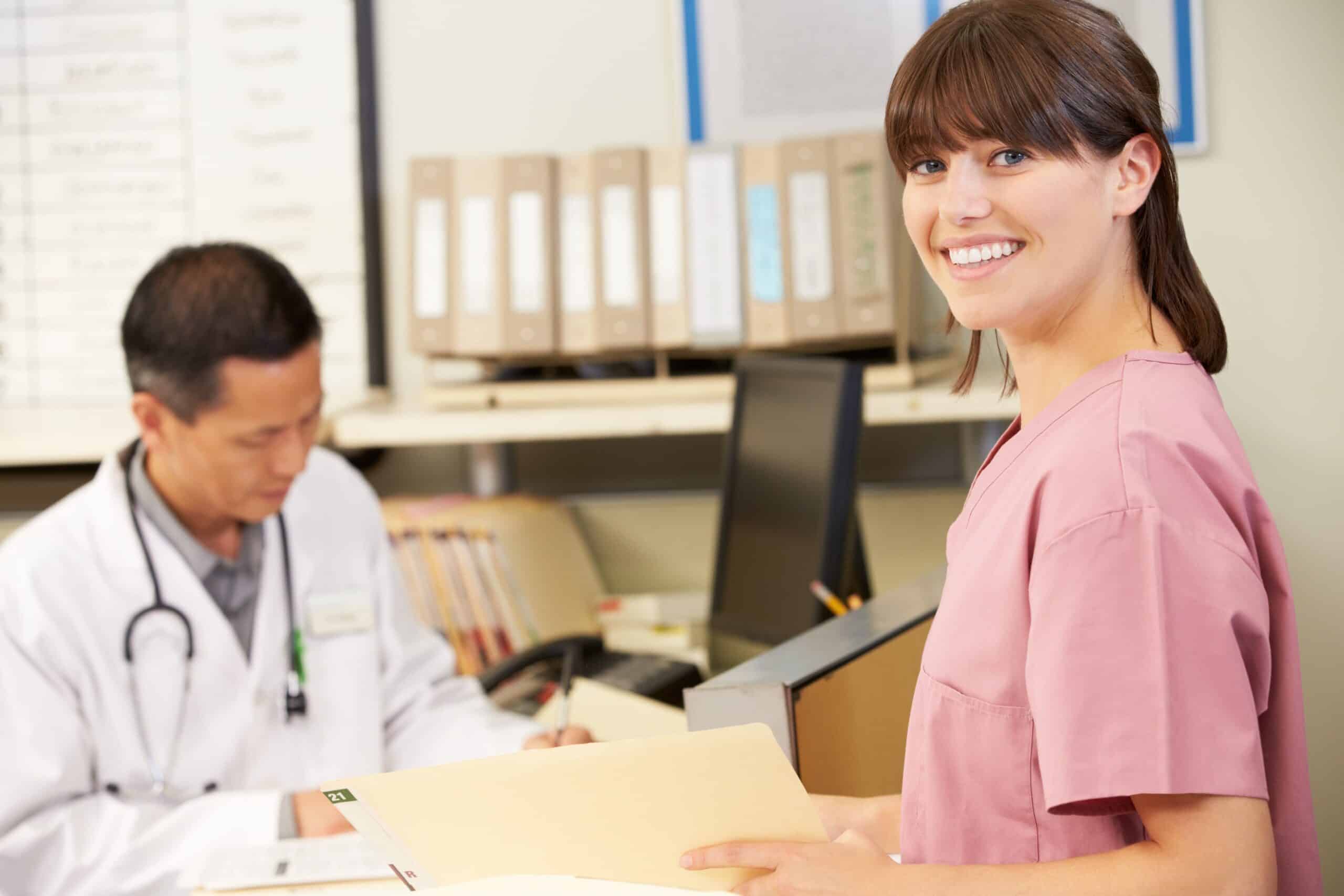 Rehab clinic administrator reviewing behavioral health billing guidelines and CPT codes at a billing workstation