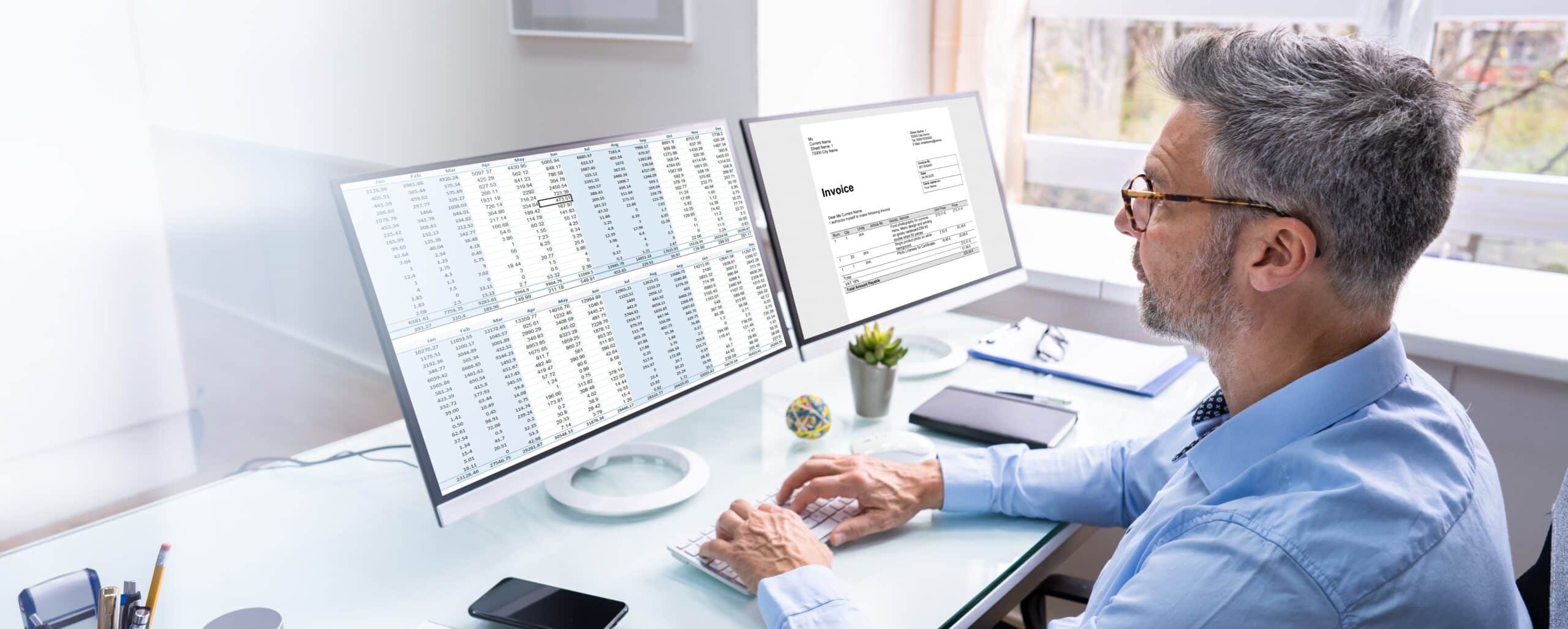 Behavioral health billing administrator reviewing claim documentation at clinic desk